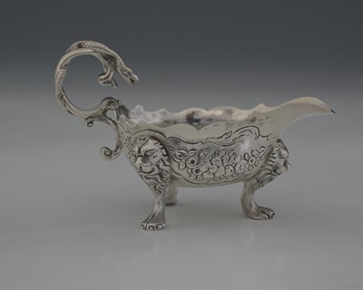 Lot 299 - A George II Rococo silver cream boat, by John...