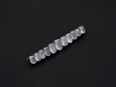 Lot 46 - A silver and moonstone bar brooch, eleven...