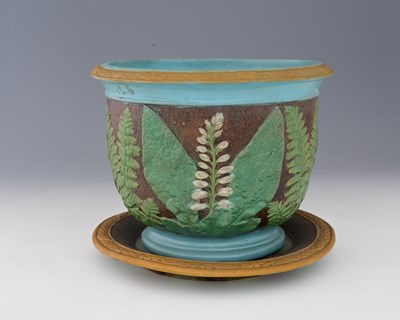 Lot 793 - A Majolica relief moulded jardiniere on stand,...