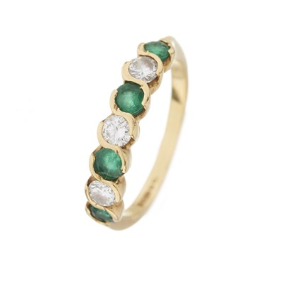 Lot 28 - An 18ct gold emerald and diamond seven-stone ring