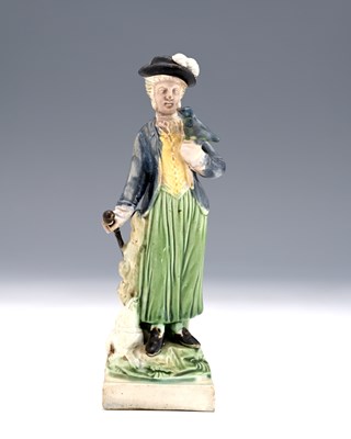 Lot 828 - A Staffordshire pearlware figure of a woman...