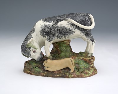 Lot 814 - A Staffordshire pearlware bull bating figure,...