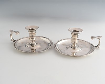 Lot 294a - A pair of George II silver chambersticks, by...