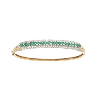Lot 158 - An 18ct gold emerald and diamond bangle bracelet