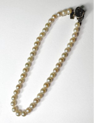 Lot 680 - A cultured pearl necklace, with sapphire and white topaz clasp