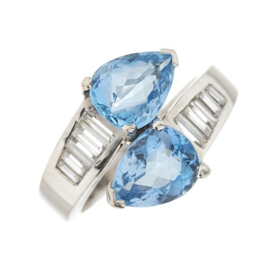 Lot 114 - An 18ct gold aquamarine and diamond crossover ring