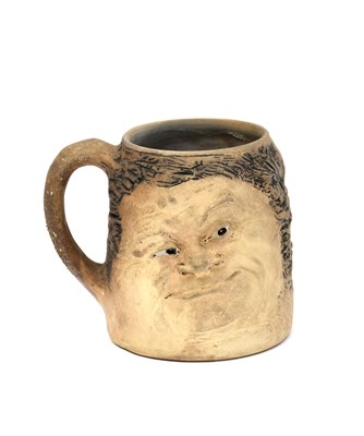 Lot 12 - A Martin Brothers stoneware grotesque tankard...