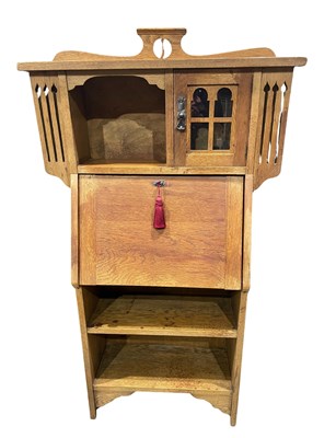 Lot 910 - An oak Arts and Crafts bureau bookcase with...