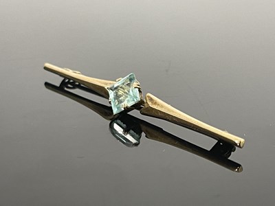 Lot 150 - A 9 carat gold and aquamarine bar brooch, the...