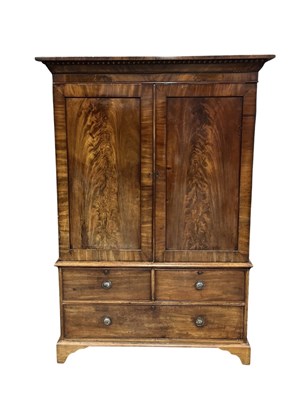 Lot 938 - An early 19th century mahogany linen press...