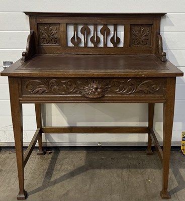 Lot 962 - An Arts and Crafts oak hall table/desk with...