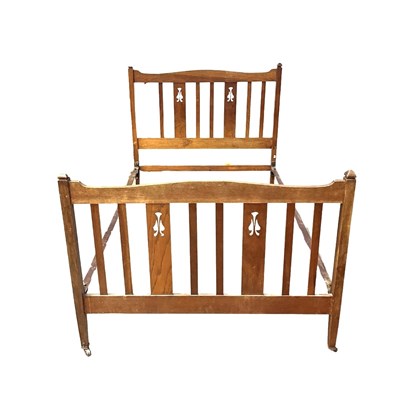 Lot 998 - A light oak arts and crafts double bed, the...