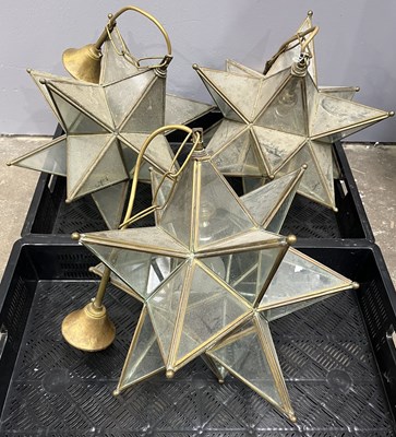 Lot 42 - Three star-form glass and brass pendant lights,...