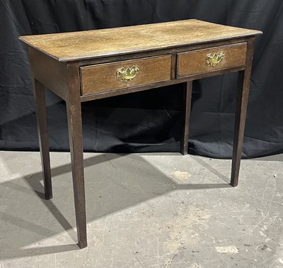 Lot 885 - A Georgian oak hall table/desk with two...