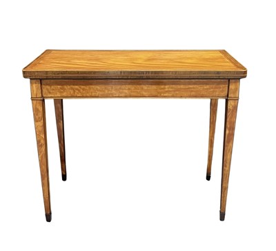Lot 887 - A Sheraton satinwood foldover card table, with...