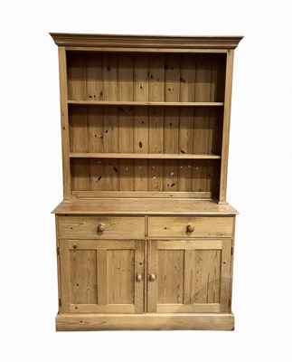 Lot 974 - A traditional stripped pine dresser, two shelf...