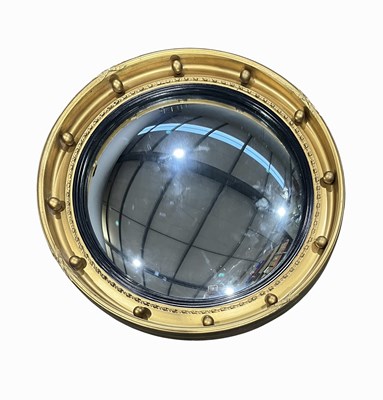 Lot 882 - A circular regency-style gilt wall mirror,...