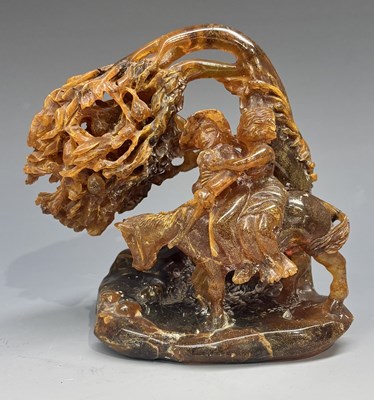 Lot 394 - A carved amber or copal figure group of a lady...