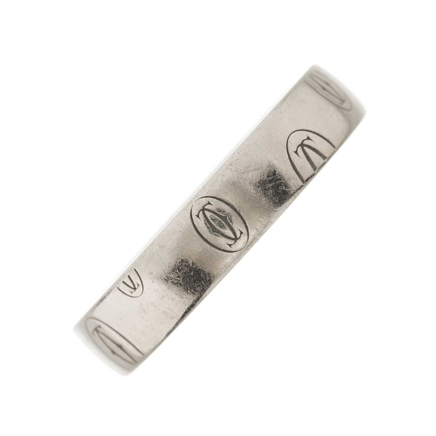 Lot 56 - Cartier, an 18ct white gold Happy Birthday logo band ring