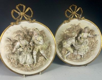 Lot 279 - A pair of Continental high relief bisque,...
