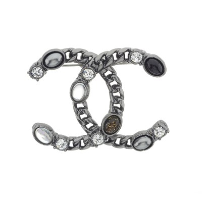 Lot 310 - Chanel, a Coco Mark gunmetal CC chain brooch.