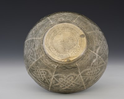 Lot 12 - A white metal bowl, panelled and stipple...