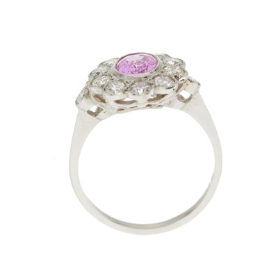 Lot 76 - A platinum pink sapphire and diamond cluster ring