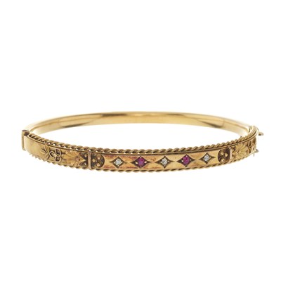 Lot 31 - An early 20th century 15ct gold ruby and diamond bangle bracelet