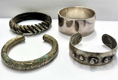 Lot 407 - Four white metal bangles