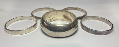 Lot 399 - A selection of white metal bangles