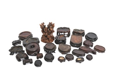 Lot 344 - Twenty six Chinese hardwood stands, the...
