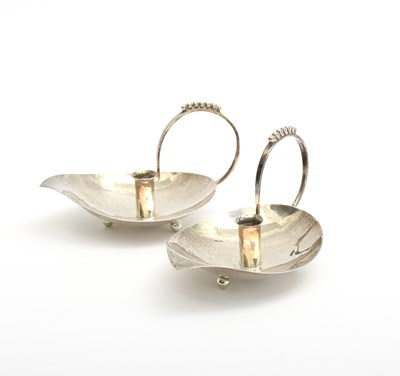 Lot 289 - A pair of A E Jones silver candleholders...