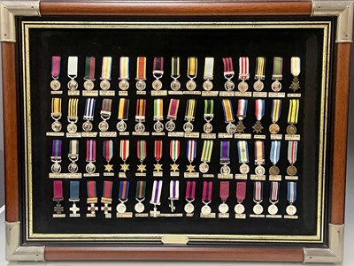 Lot 518 - A framed display of miniature replica British...