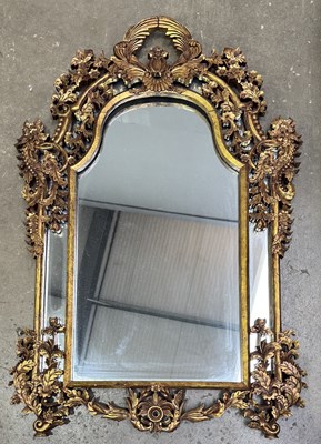 Lot 577 - An oriental mirror, arched top form within a...