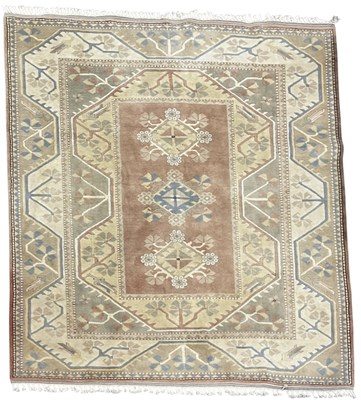 Lot 650 - A large woollen Turkish rug, Oushak style,...