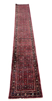 Lot 644 - A large Persian wool Hosseinabad-type runner...