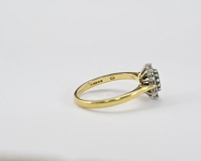 Lot 10 - An 18ct gold emerald and diamond cluster ring