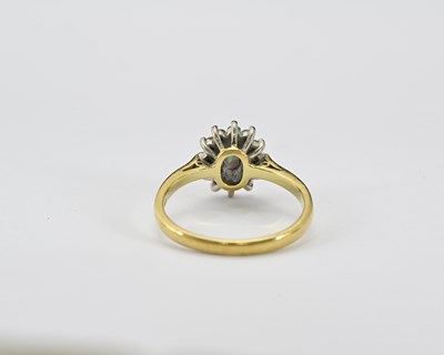 Lot 10 - An 18ct gold emerald and diamond cluster ring