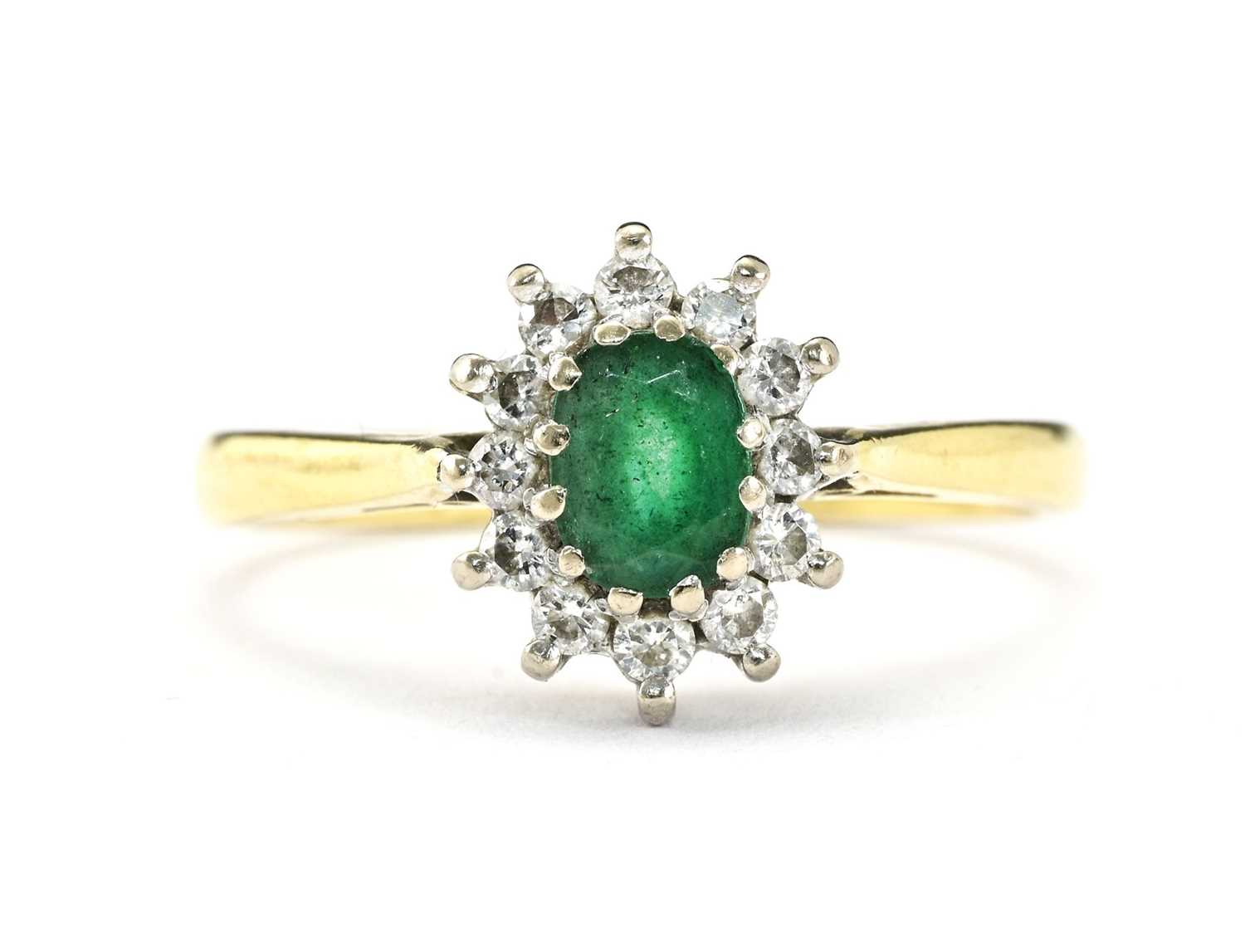 Lot 10 - An 18ct gold emerald and diamond cluster ring