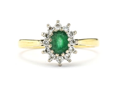 Lot 10 - An 18ct gold emerald and diamond cluster ring