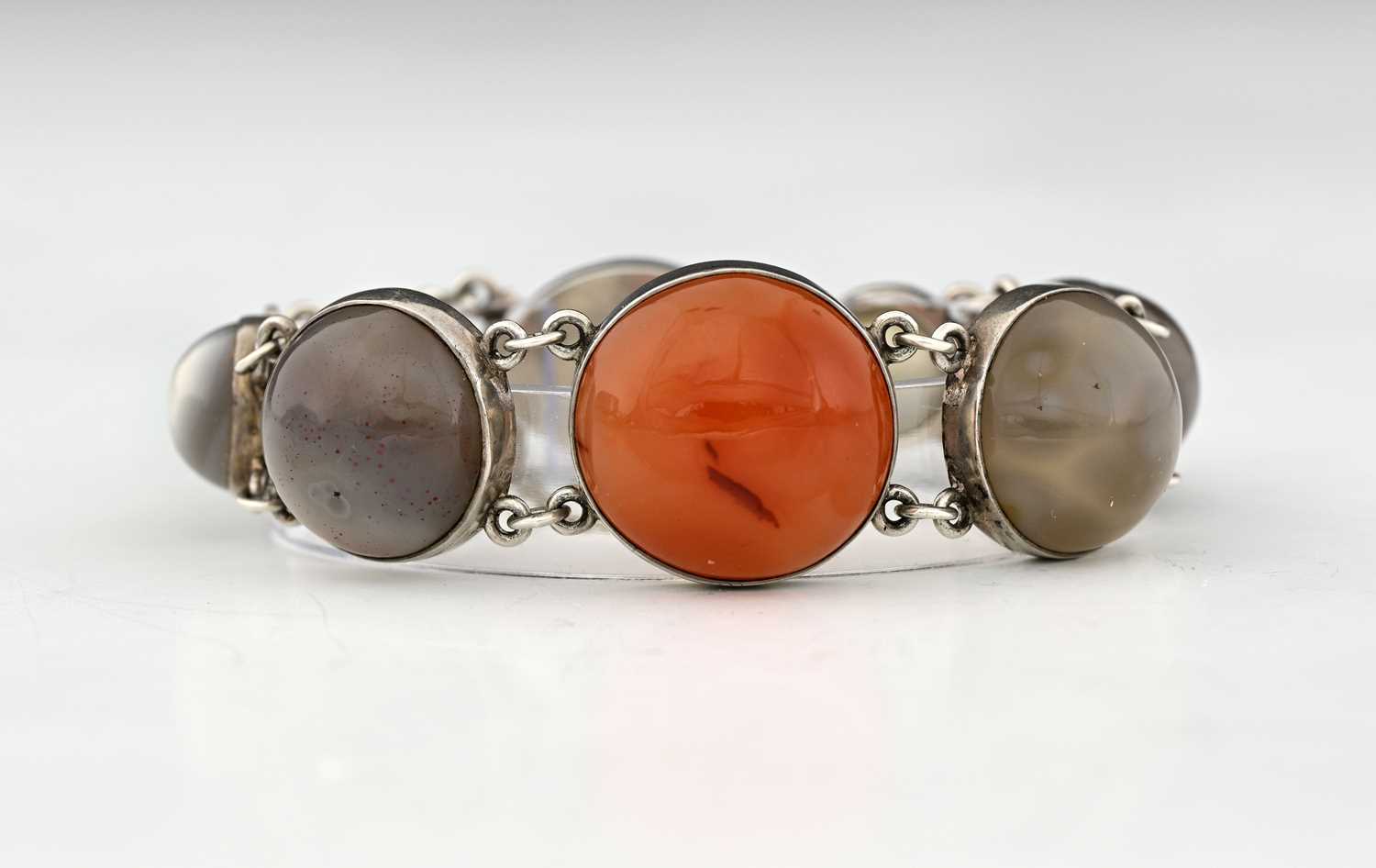Lot 29 - An Arts and Crafts agate and silver bracelet,...