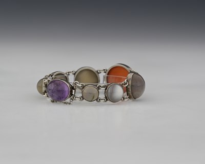 Lot 29 - An Arts and Crafts agate and silver bracelet,...