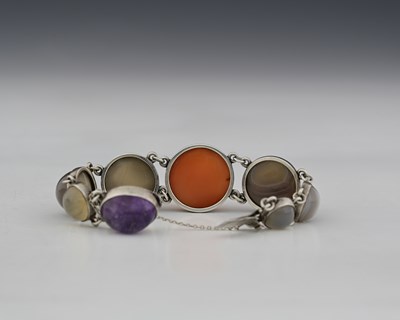 Lot 29 - An Arts and Crafts agate and silver bracelet,...