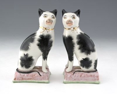 Lot 626 - A pair of ceramic chimney models of cats,...
