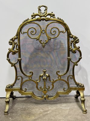 Lot 582 - A 19th century cast brass fire screen, central...
