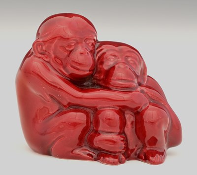 Lot 617 - A Royal Doulton flambe hugging monkey figure...