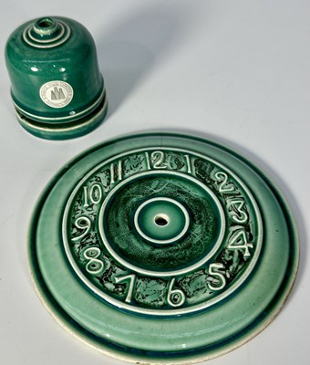 Lot 173 - A Ruskin ceramic green clock face with Arabic...