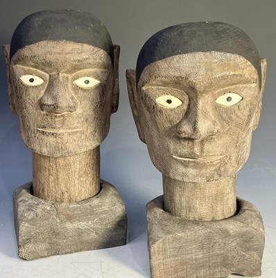 Lot 242 - A pair of Indonesian carved wooden heads with...