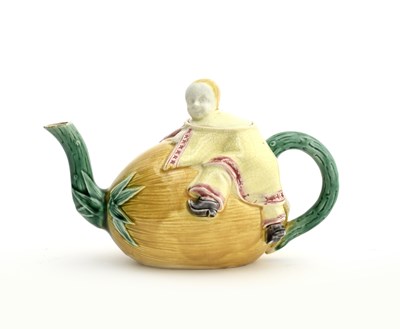 Lot 177 - A majolica novelty teapot and cover probably...