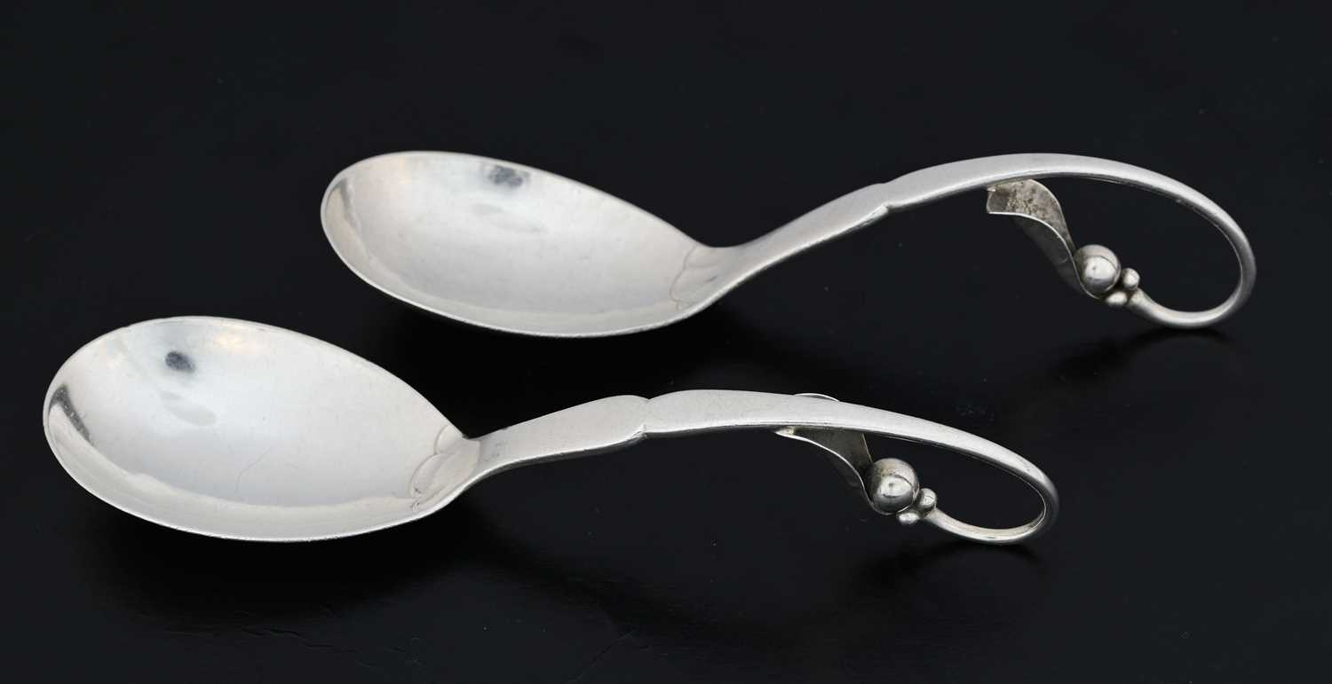 Lot 71 - Georg Jensen, two silver preserve spoons,...
